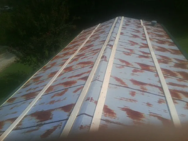 Rusted metal roof panels with new wood purlins before replacement — Storm Damage Roof Repair in Turners Station by Roofing Brothers